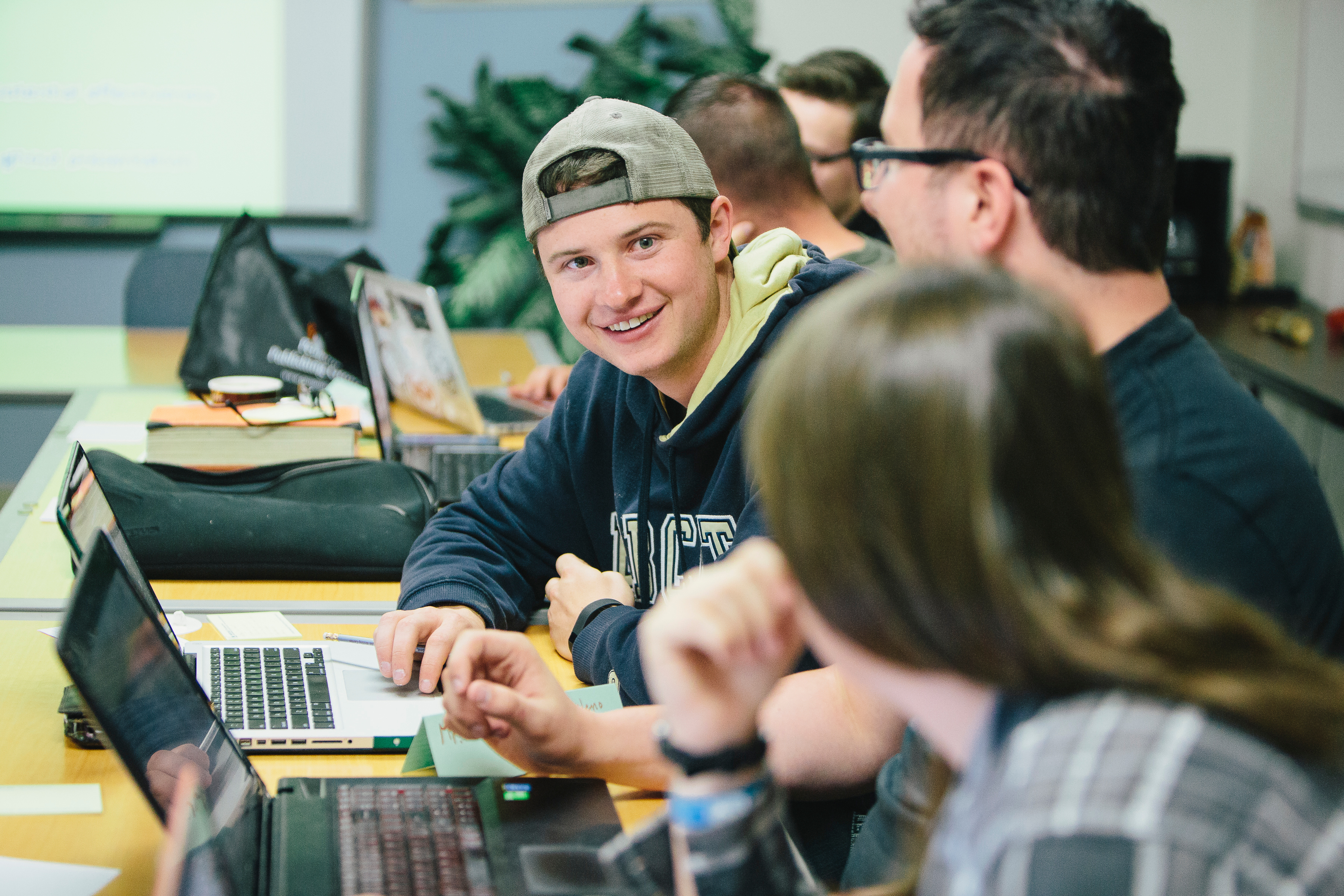 Student smiling at computer