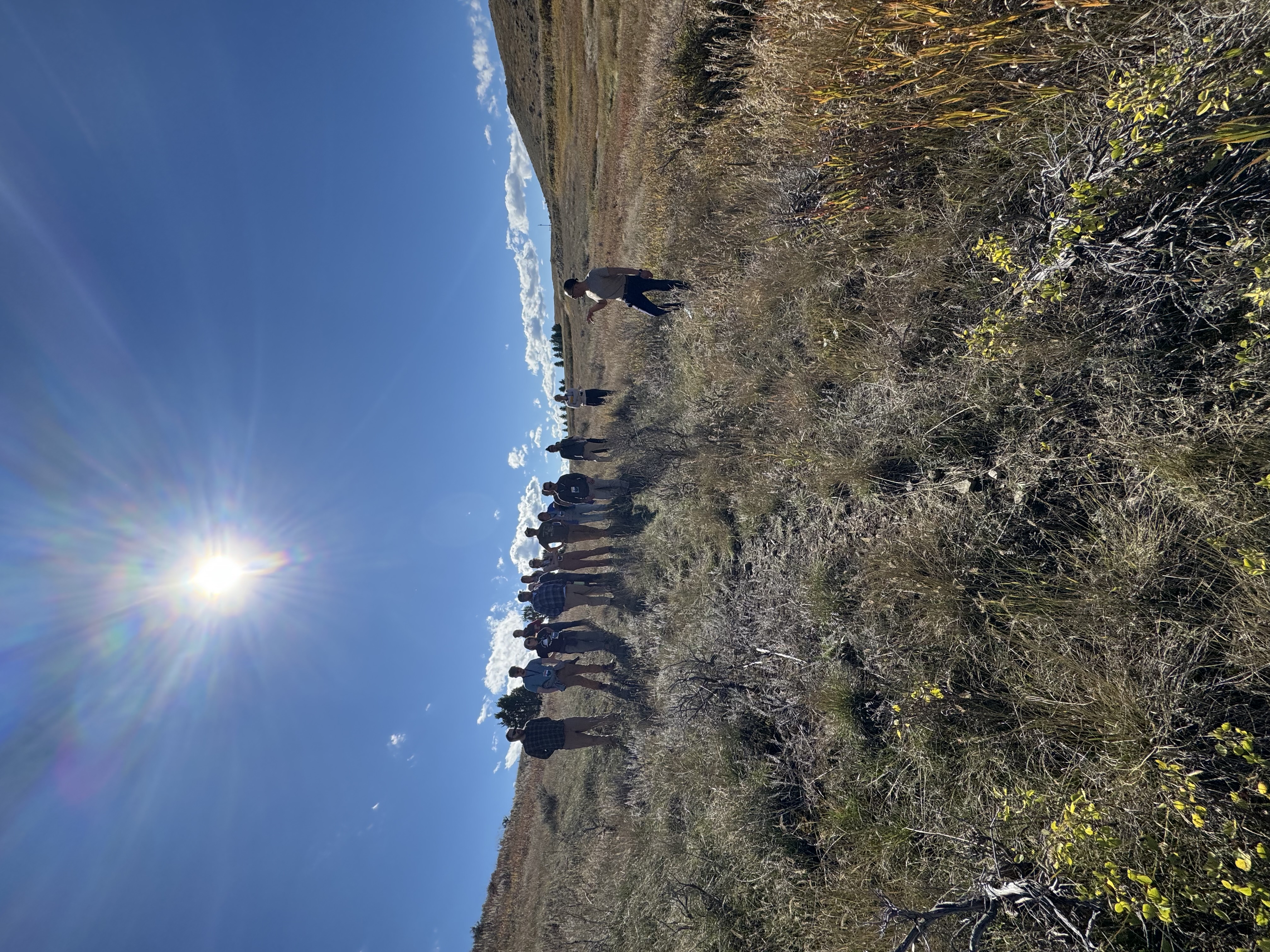 People standing in a circle outside.