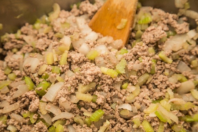 Pot of basic meat mix with a wooden spoon.