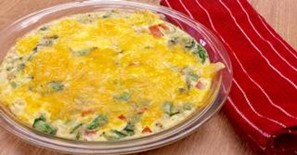 A pan holding a Garden Vegetable Frittata placed on a red dish towel.