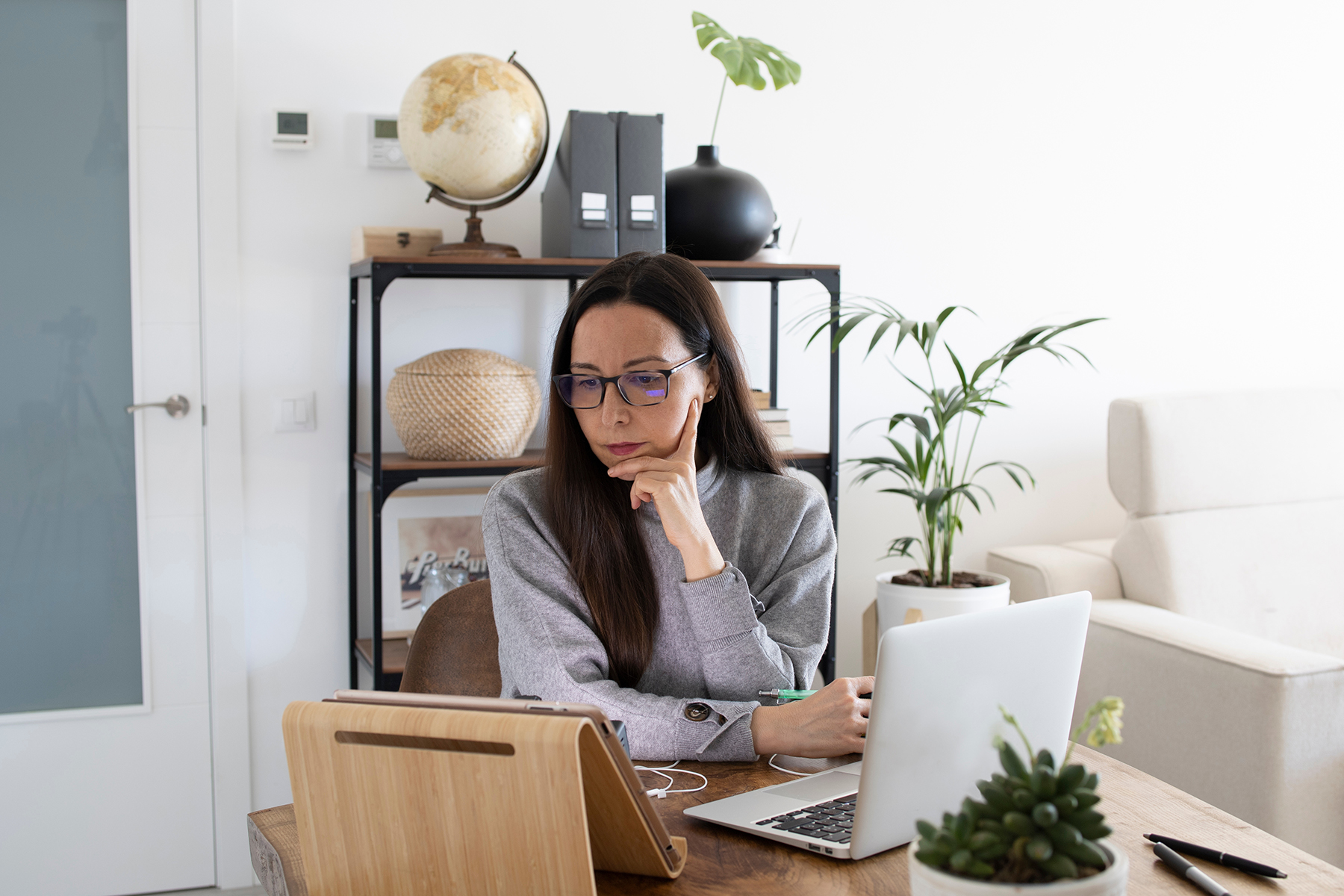 Woman working remotely from home office.