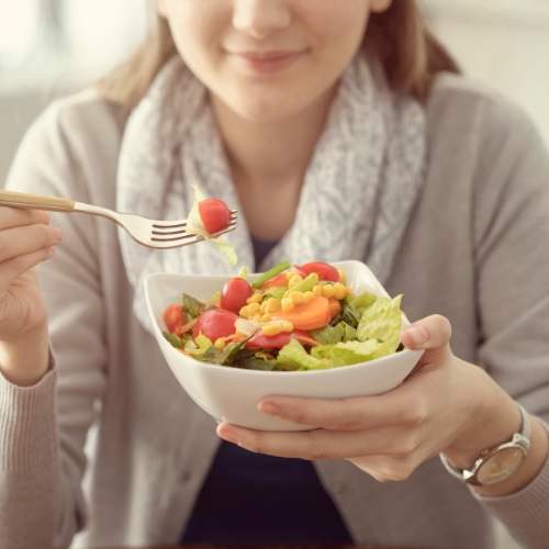 Cancer Prevention Blog woman eating veggies