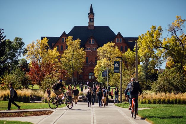 Montana Hall with students walking in front of building.