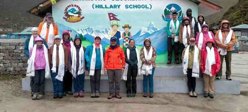 The group stands in front of the Hillary School.