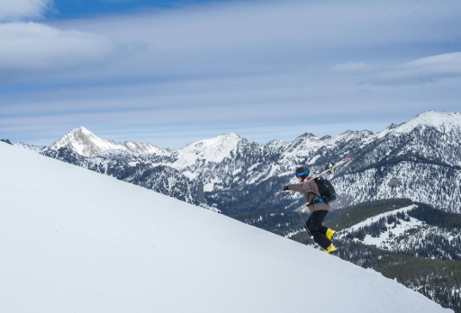 student hiking with skis